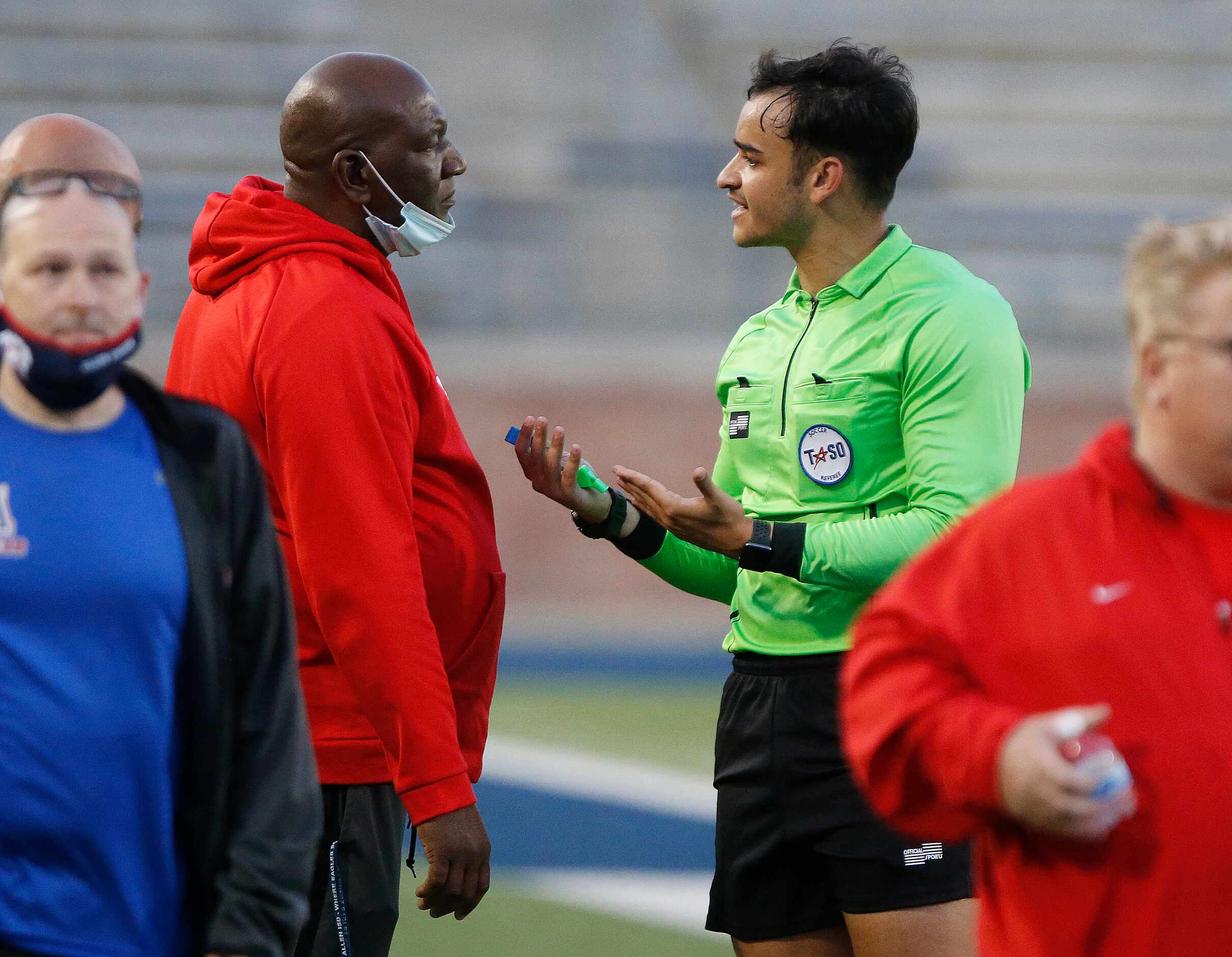 Allen head coach Kim Fullerton (left) has call explained to him by the ref during the first...