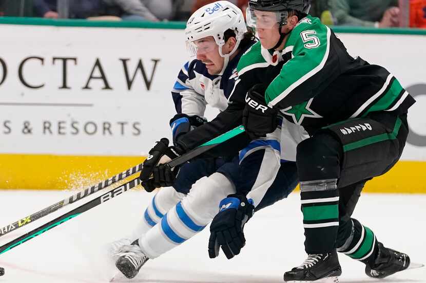 Winnipeg Jets center Michael Eyssimont (23) skates with the puck against Dallas Stars...