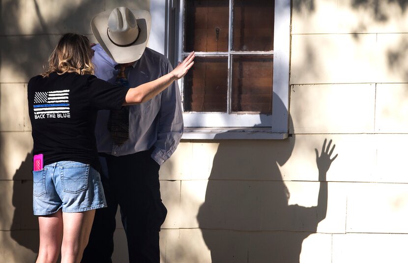 A woman prays with a man after a fatal shooting at the First Baptist Church in Sutherland...