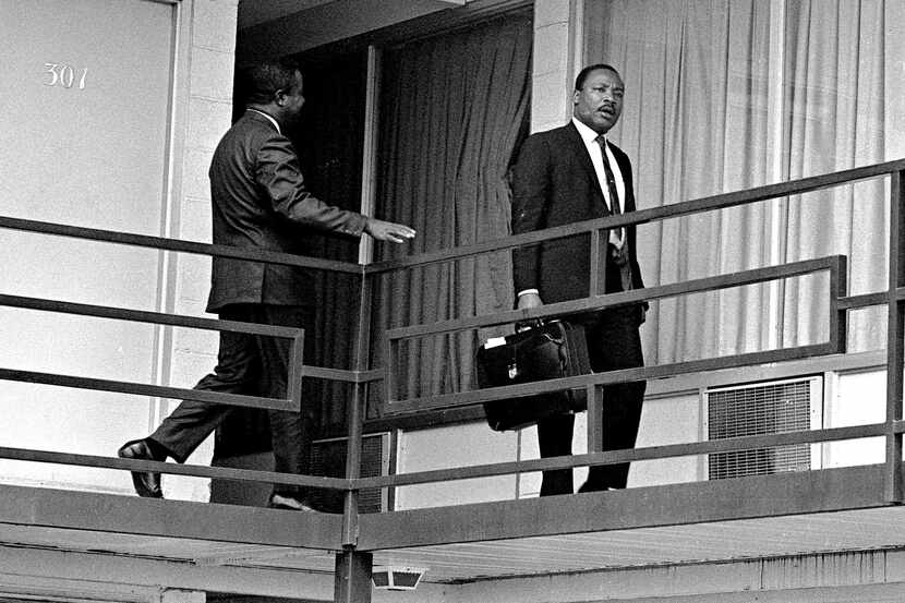This April 3, 1968 file photo shows Rev. Martin Luther King, Jr. walking across the balcony...