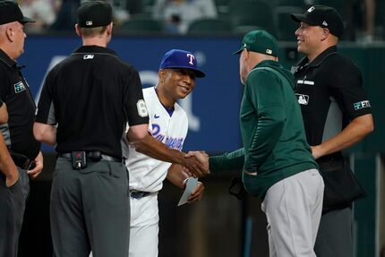 Texas Rangers interim manager Tony Beasley, center, and Oakland Athletics manager Mark...