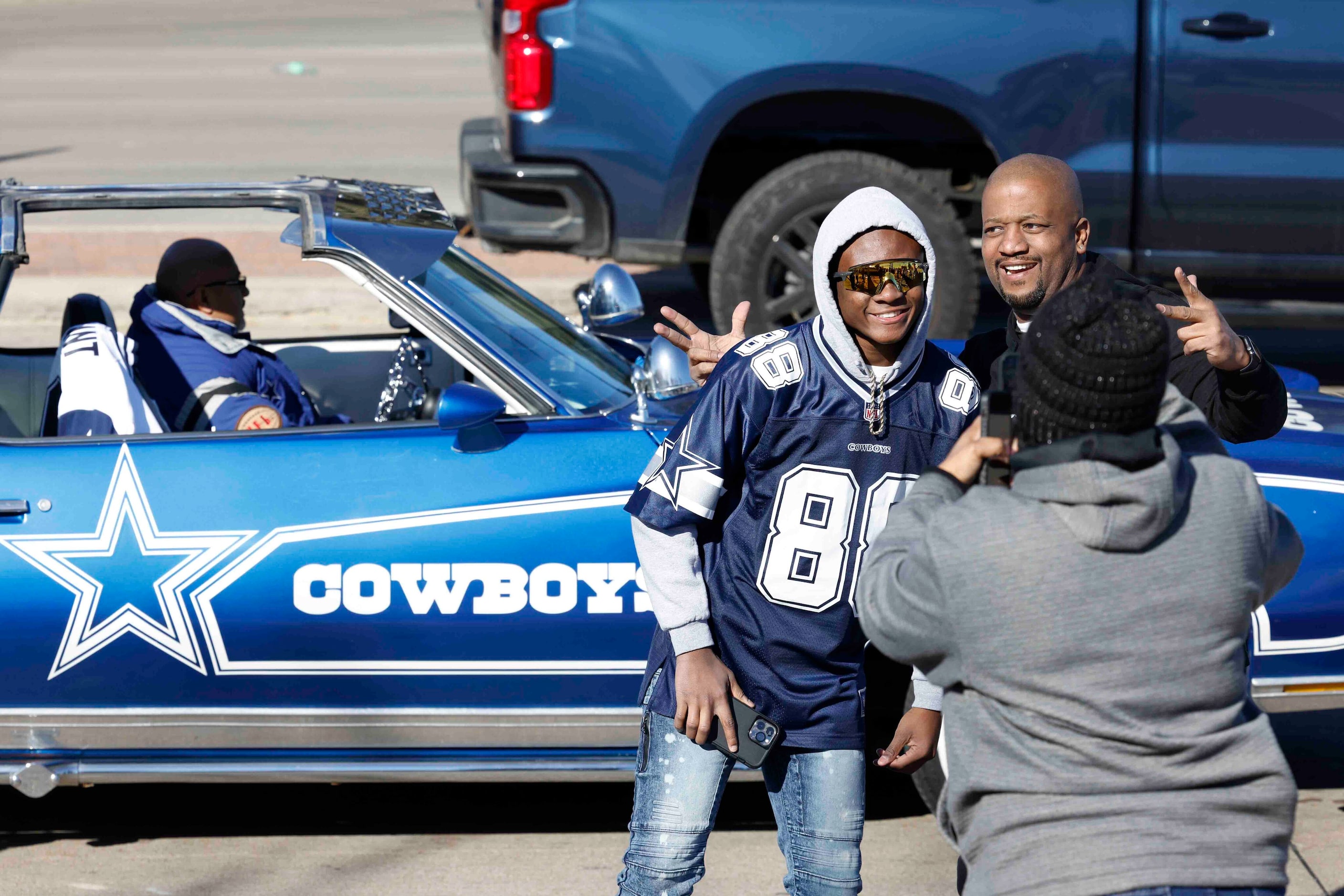 Fans pose for pictures as they make their way towards the AT&T Stadium ahead of a NFL game...