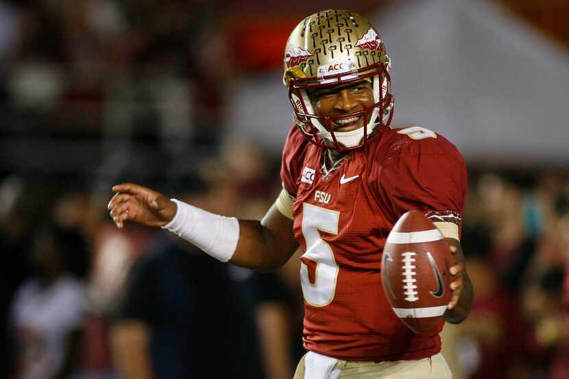 FILE - In this Nov. 2, 2013 file photo, Florida State quarterback Jameis Winston (5) smiles...