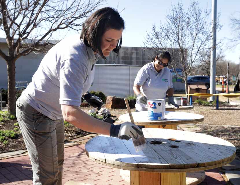 Jaime Bretzmann, left, and Nalini Joshi paint tables at the Environmental Education Center...