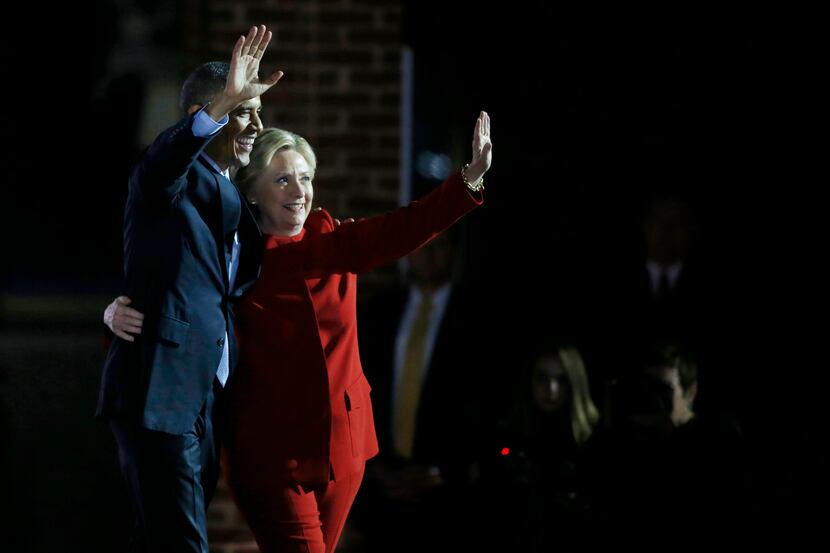 President Barack Obama and democratic presidential candidate Hillary Clinton wave to the...