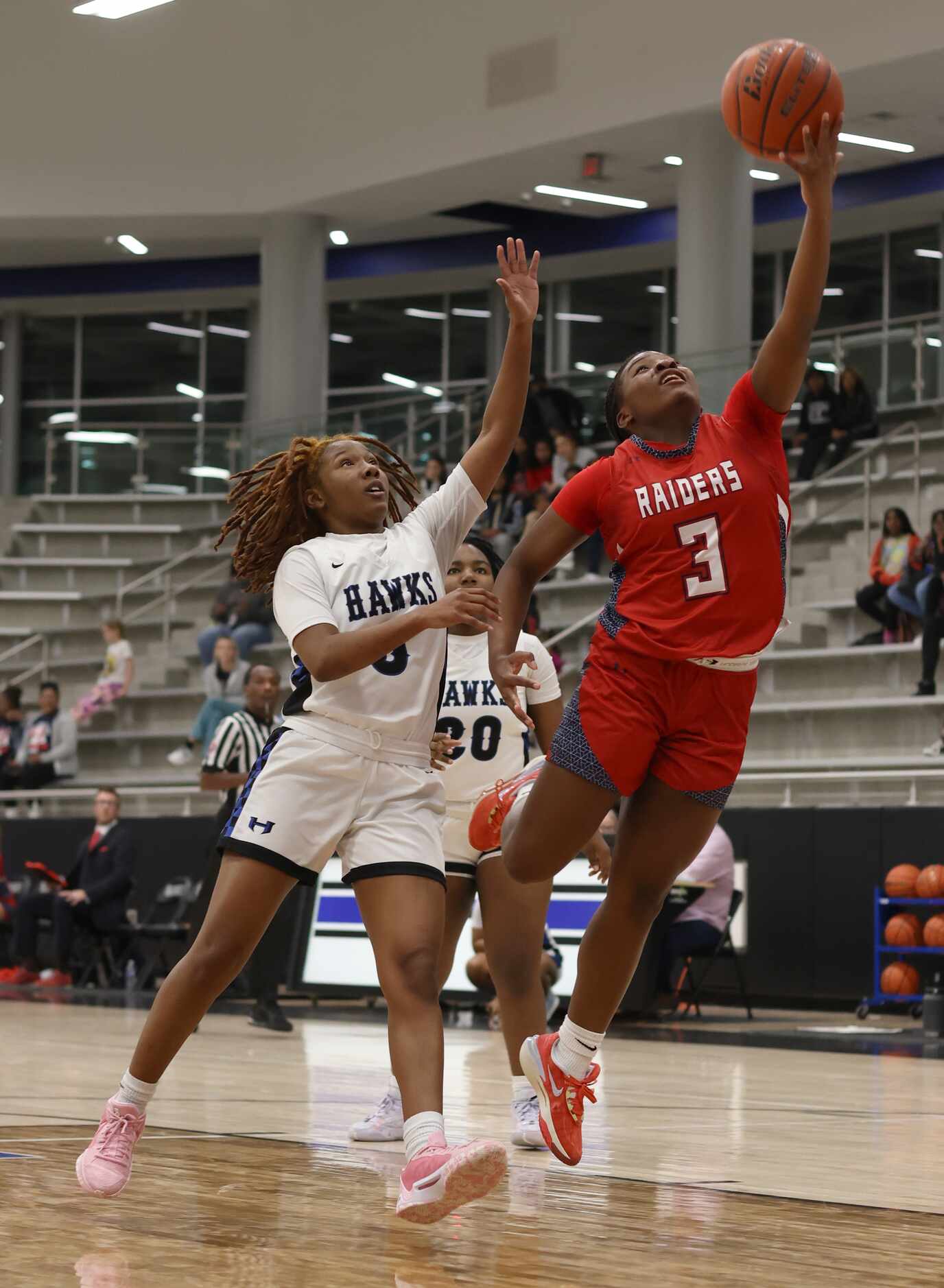 Denton Ryan guard Atiya Everett (3) puts up a shot as Hebron guard Sydnee Jones (5) moves in...