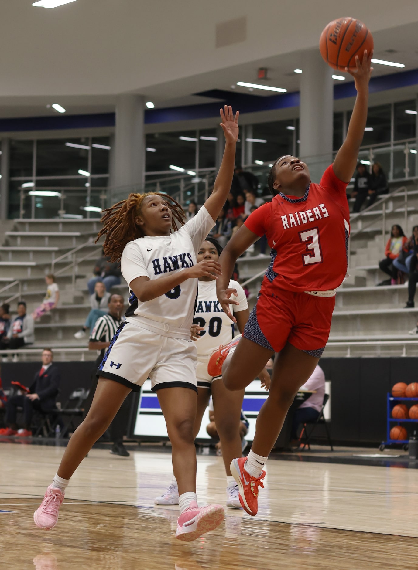 Denton Ryan guard Atiya Everett (3) puts up a shot as Hebron guard Sydnee Jones (5) moves in...