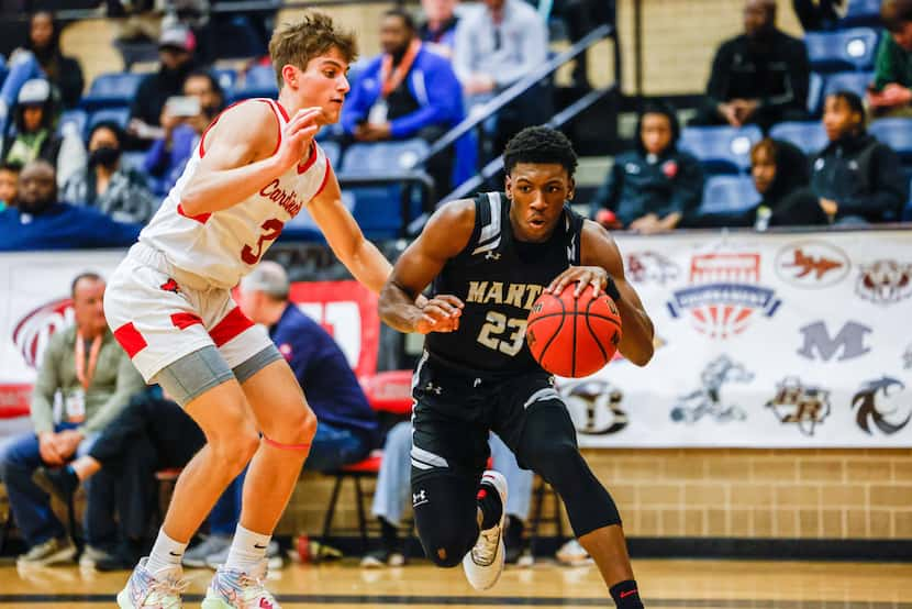 Arlington Martin's Kordelius Jefferson (23) faced off against John Paul II's Ofri Kauf (3)...