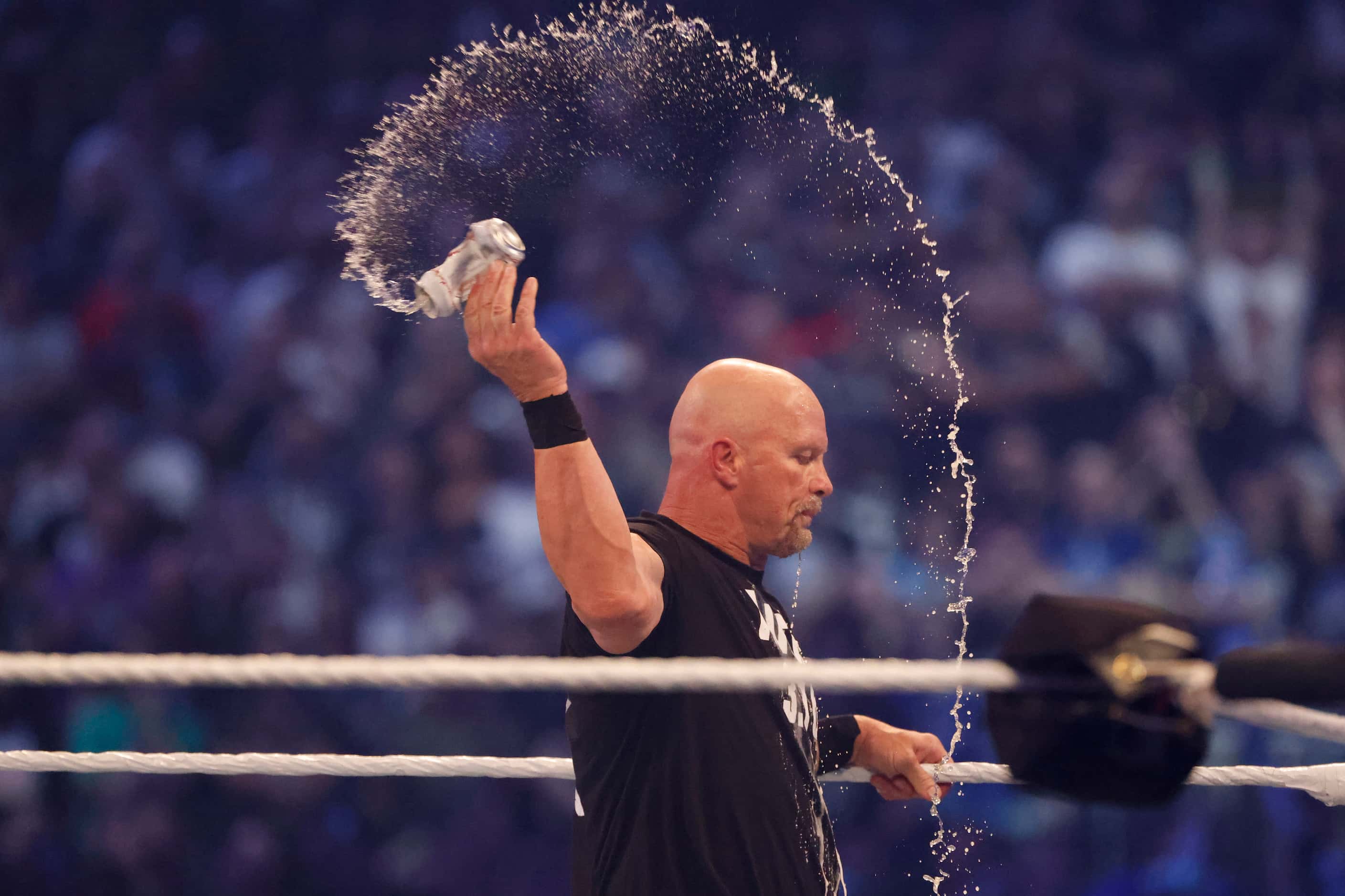 Cold Stone Steve Austin discards a beer he drank while wrestling Kevin Owens during...
