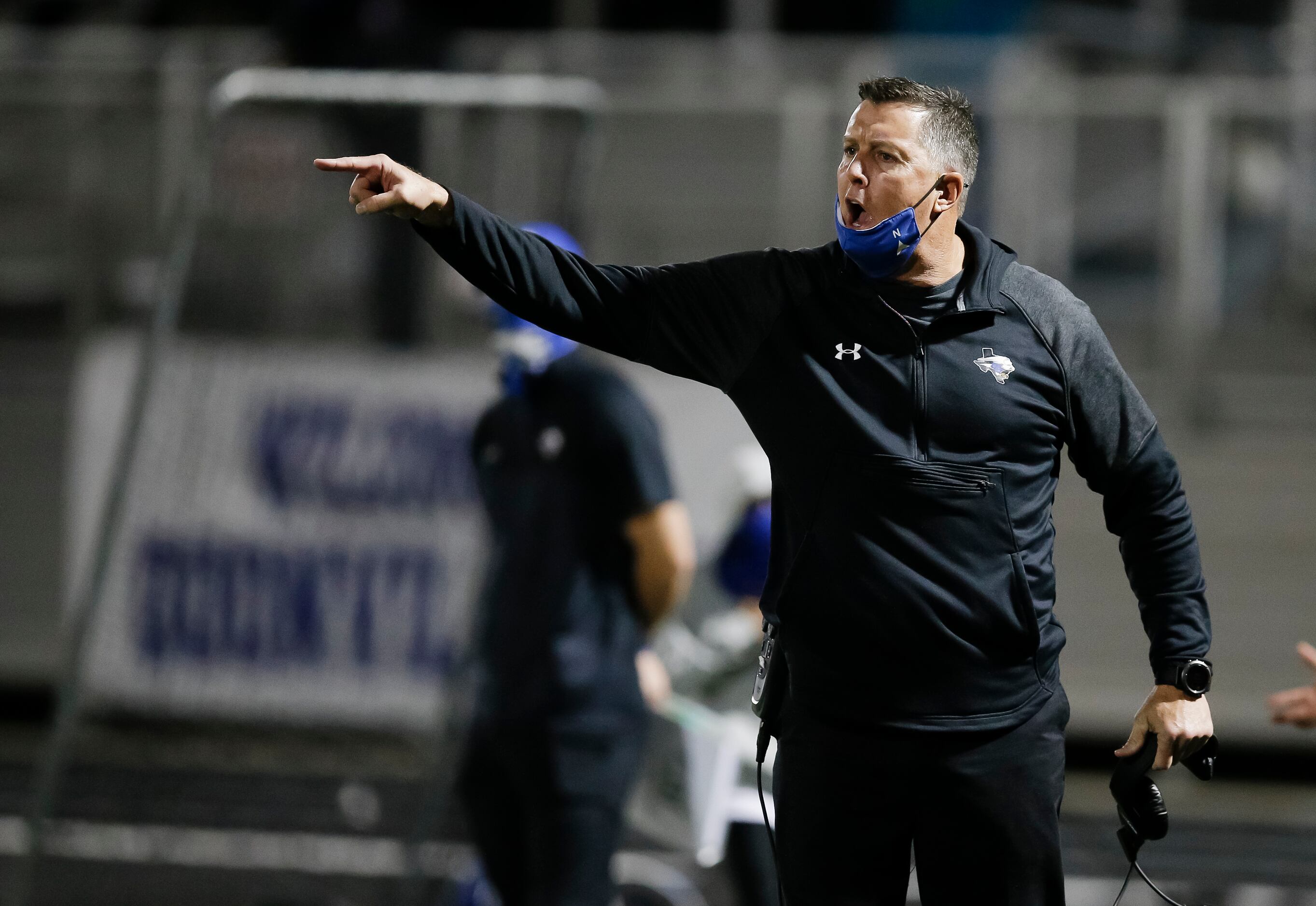North Forney head coach Randy Jackson shouts instructions to his players during the second...