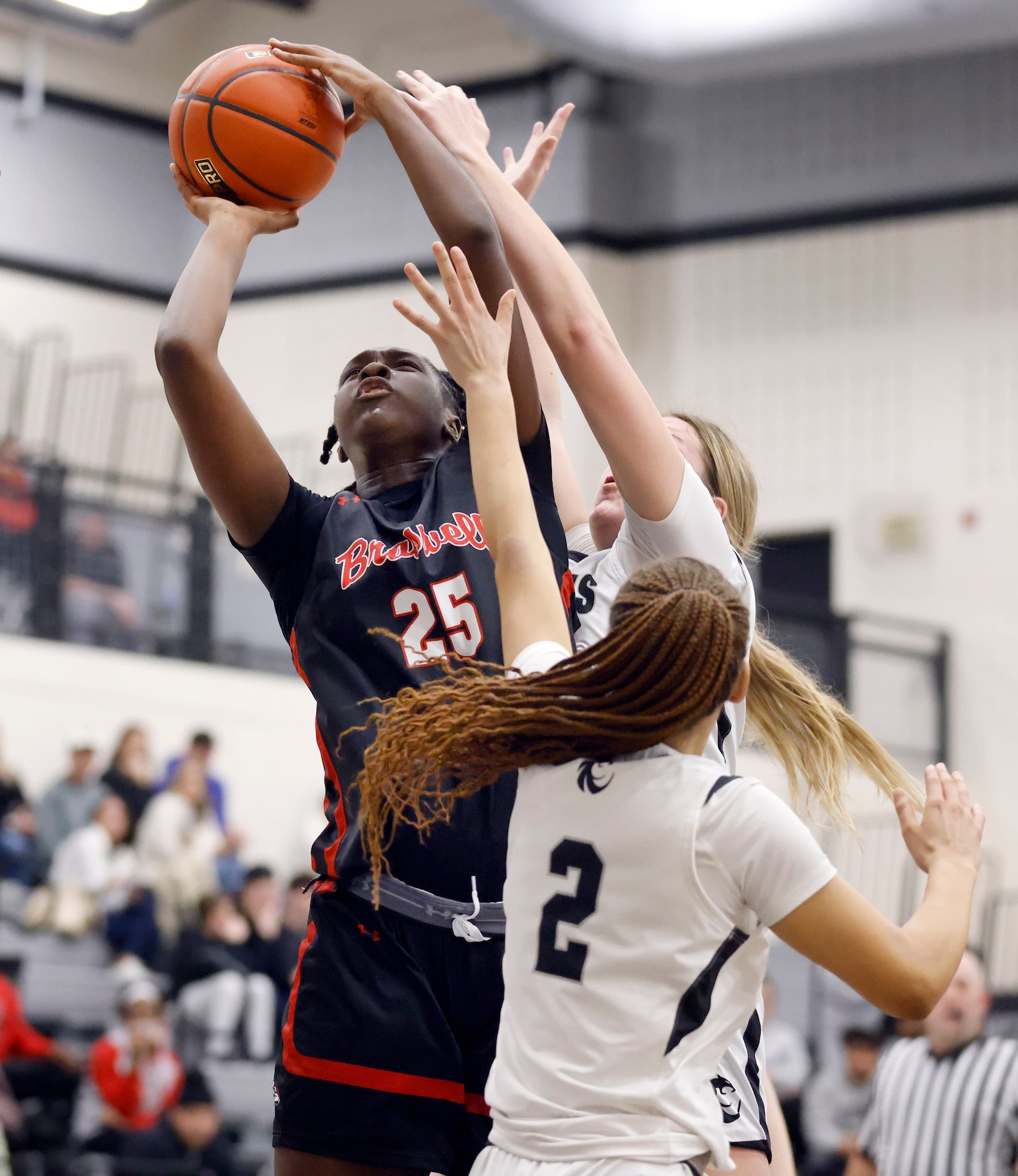 Denton Braswell cetner Amaya McDonald (25) puts up a shot over Denton Guyer’s Audrey...