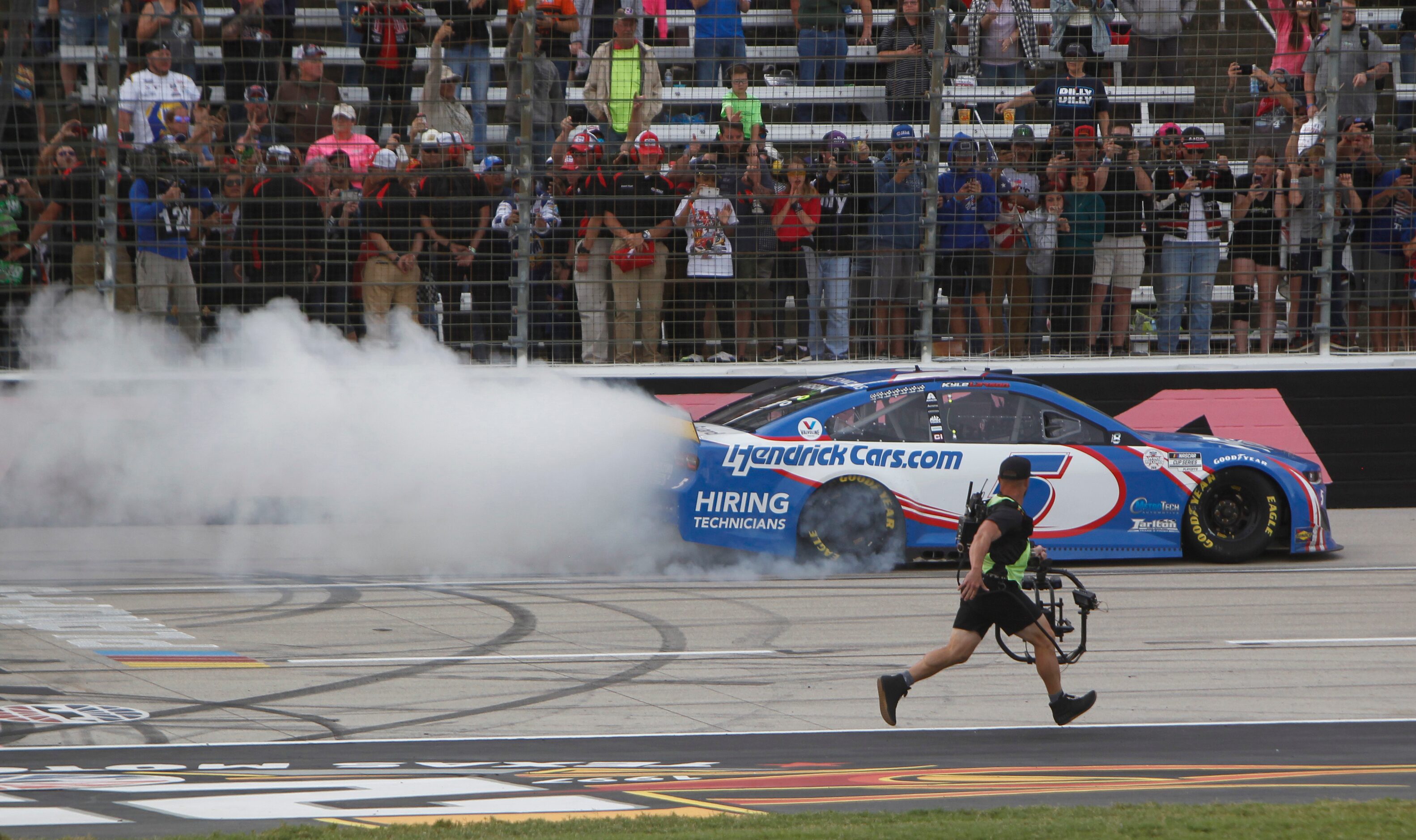 Kyle Larson spins out in celebration of his first place win after driving the number 5...