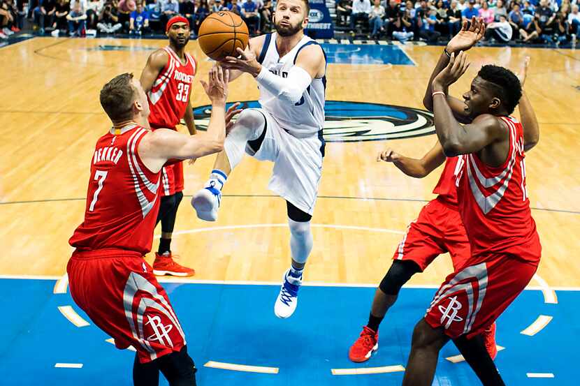 Dallas Mavericks guard J.J. Barea (5) drives to the basket past Houston Rockets forward Sam...