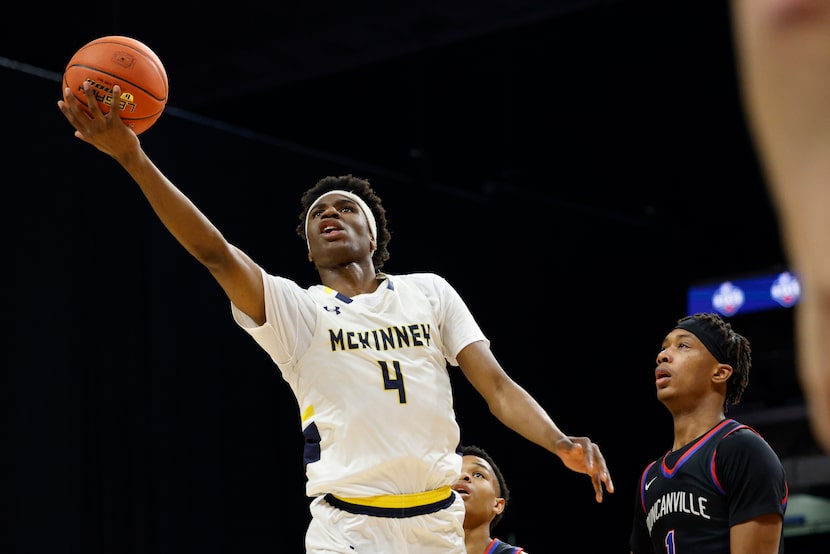 McKinney guard Ja'Kobe Walter (4) attempts a layup as Duncanville forward Ron Holland (1)...