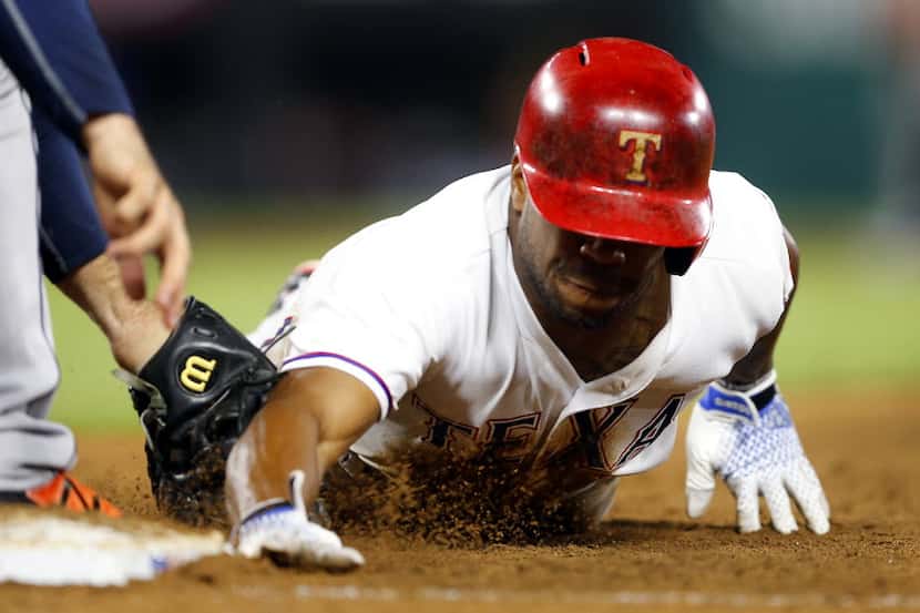 Texas Rangers runner Delino DeShields (3) is tagged out by Houston Astros first baseman...