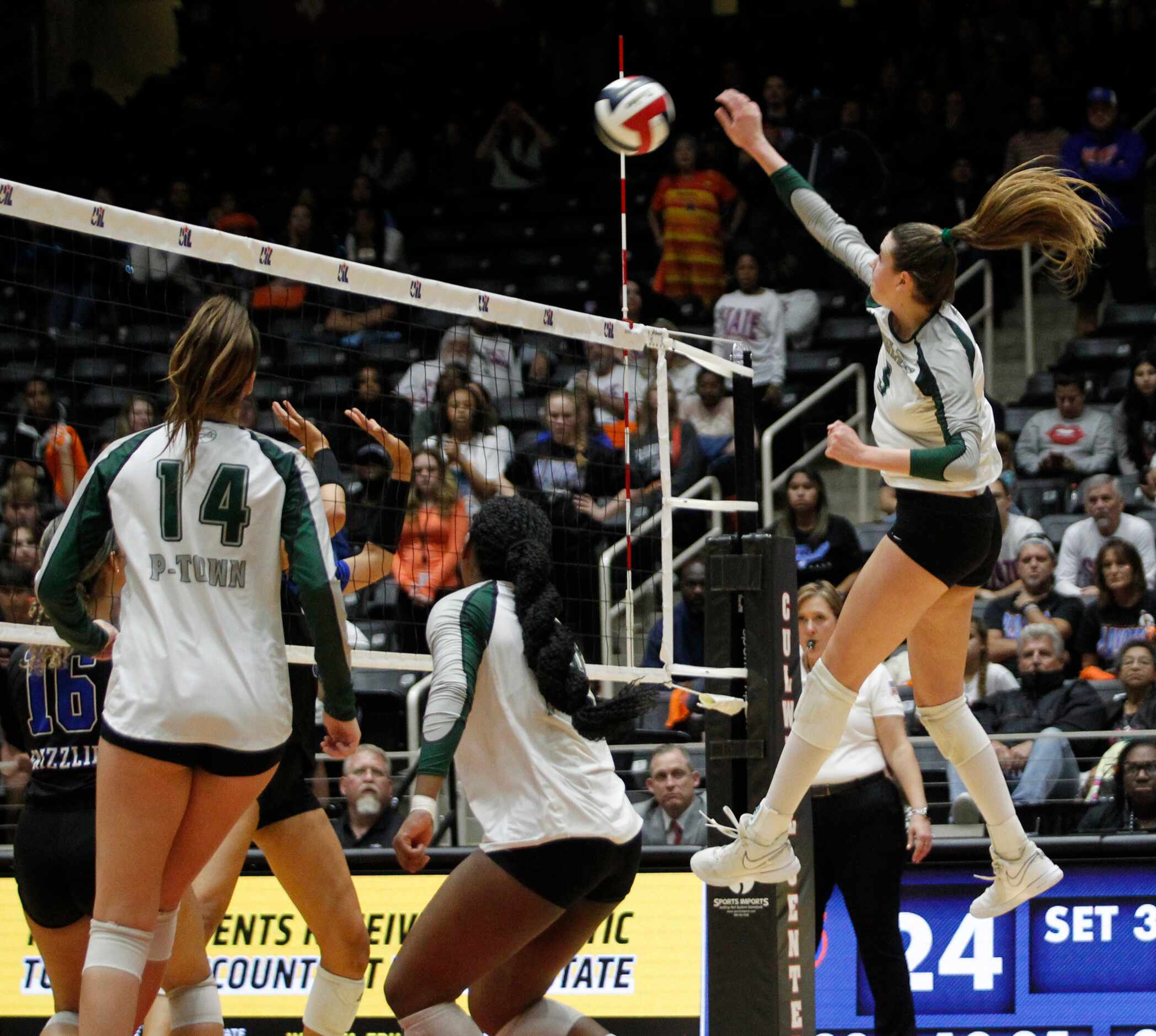 Prosper senior Ayden Ames (9), right, powers a spike for a score during the 3rd set of their...