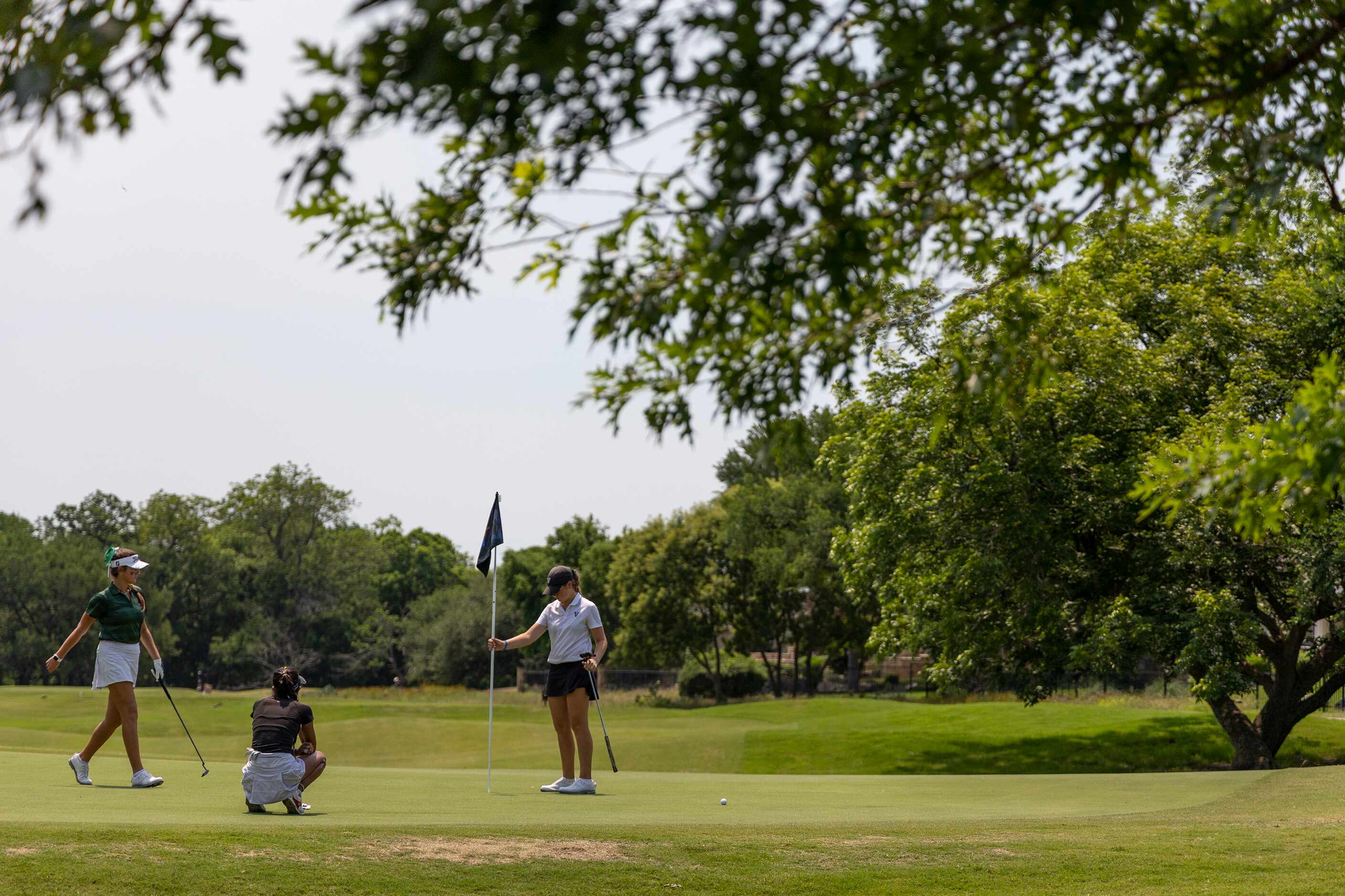 The Woodlands Veronika Exposito, Hebron’s Symran Shah, and Vandegrift’s Sydney Givens putts...