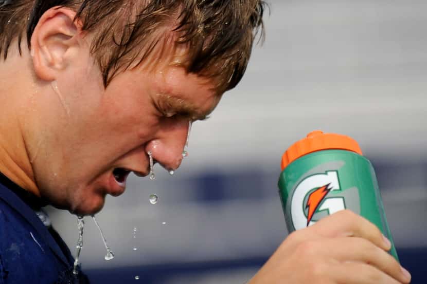 Senior, Caleb Smith pores water on his head during a break at Prestonwood Christian's first...