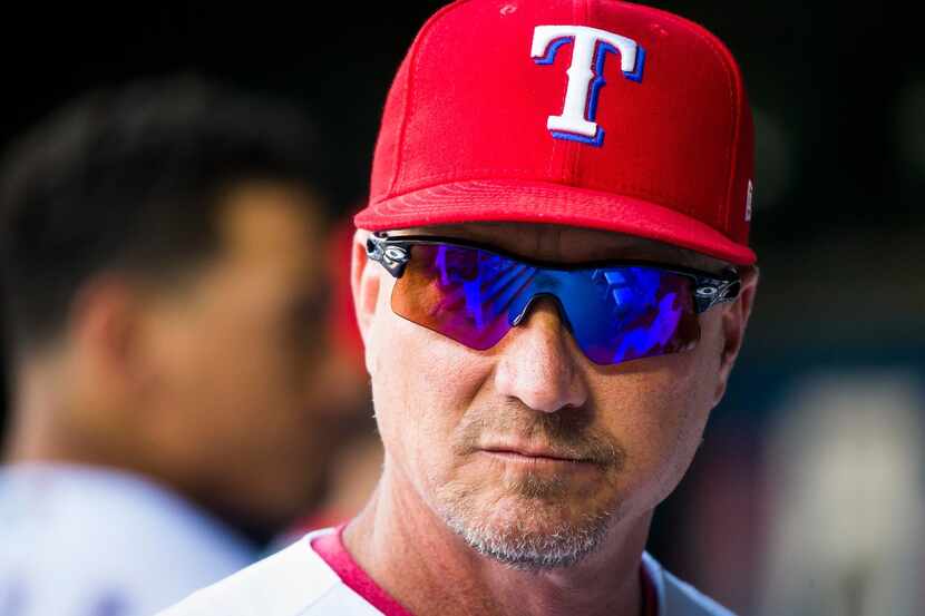 Texas Rangers manager Jeff Banister looks out from the dugout before a game against the...