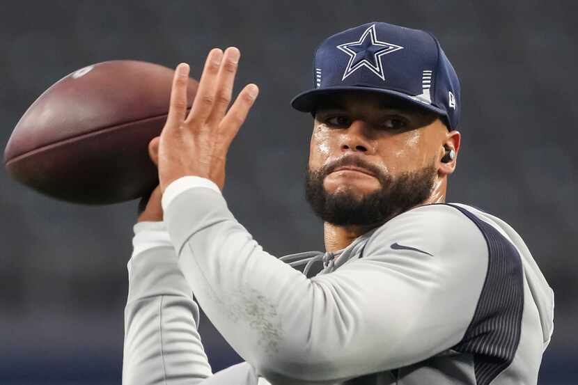 Dallas Cowboys quarterback Dak Prescott warms up before an NFL football game against the...