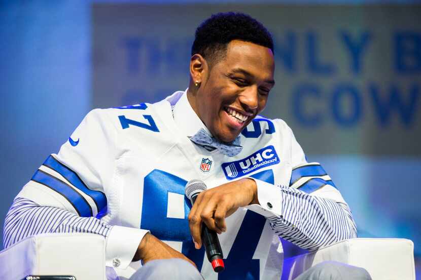 The Dallas Cowboys first round draft pick, defensive end Taco Charlton, laughs as he is...