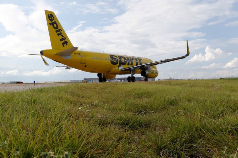 A Spirit Airlines plane taxis at DFW International Airport.