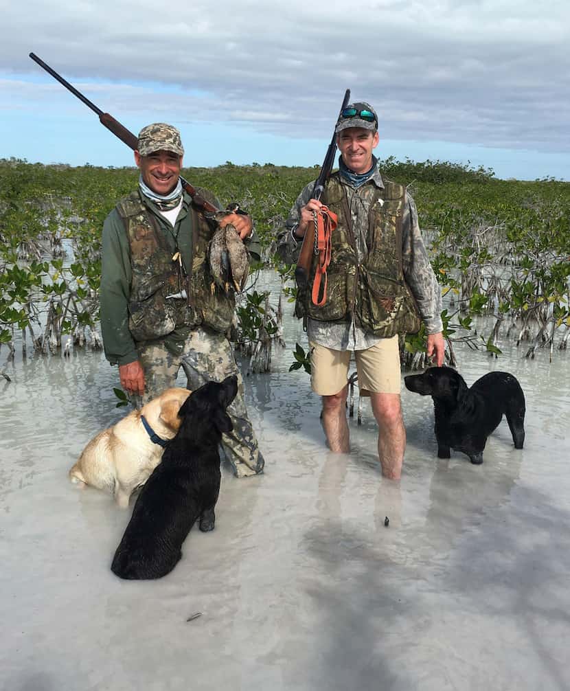 Tom Horton (right) and his black Lab, Tango, are shown on a duck hunting trip to the Bahamas...
