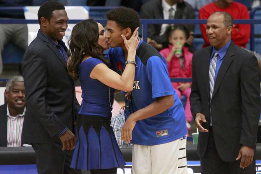 Plano West Wolves guard Avery Johnson, Jr. (10)  gets a kiss from his mother, Cassandra...
