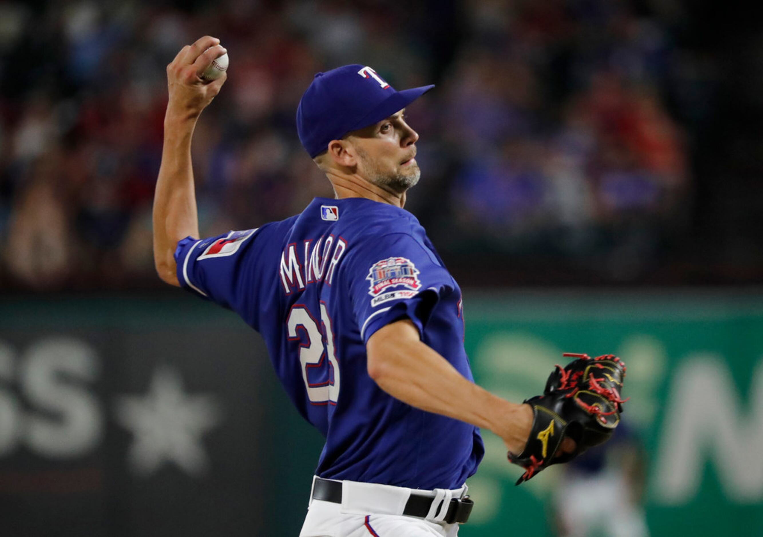 Texas Rangers' Mike Minor throws to the Oakland Athletics in the fifth inning of a baseball...