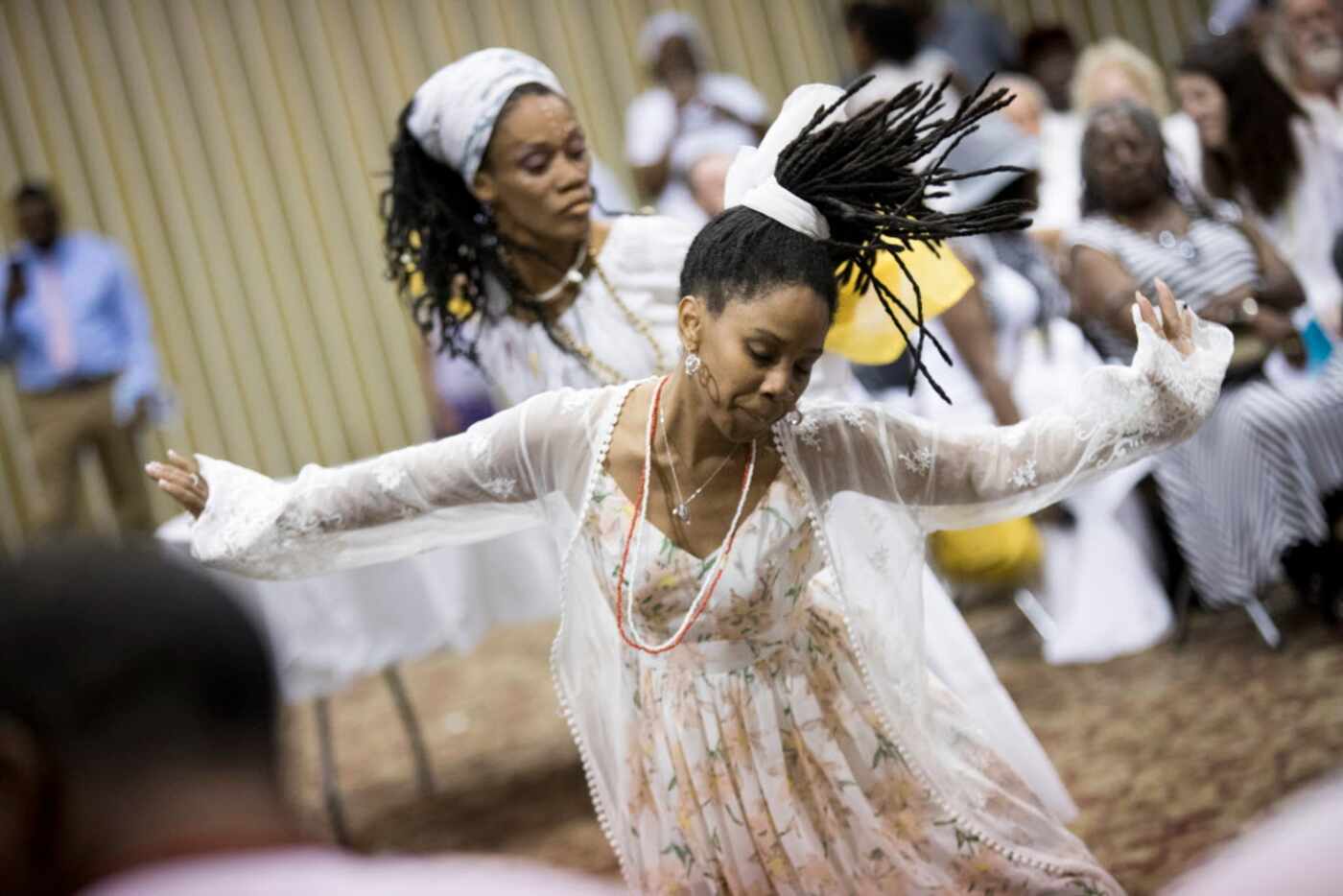 Attendees dance during a memorial service for Arthur Riggins, also affectionately known as...