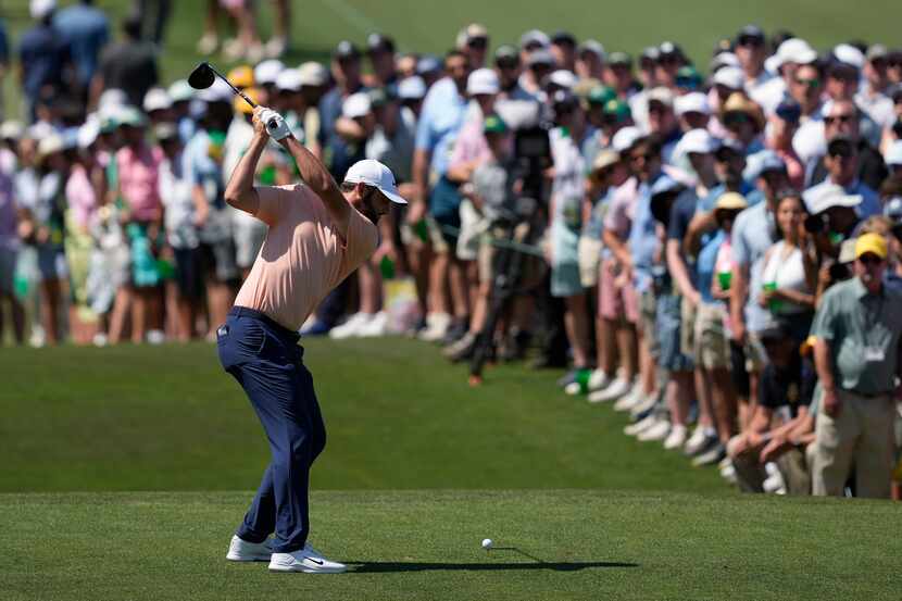 Scottie Scheffler hits his tee shot on the third hole during final round at the Masters golf...