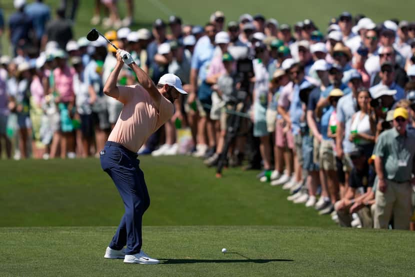 Scottie Scheffler hits his tee shot on the third hole during final round at the Masters golf...