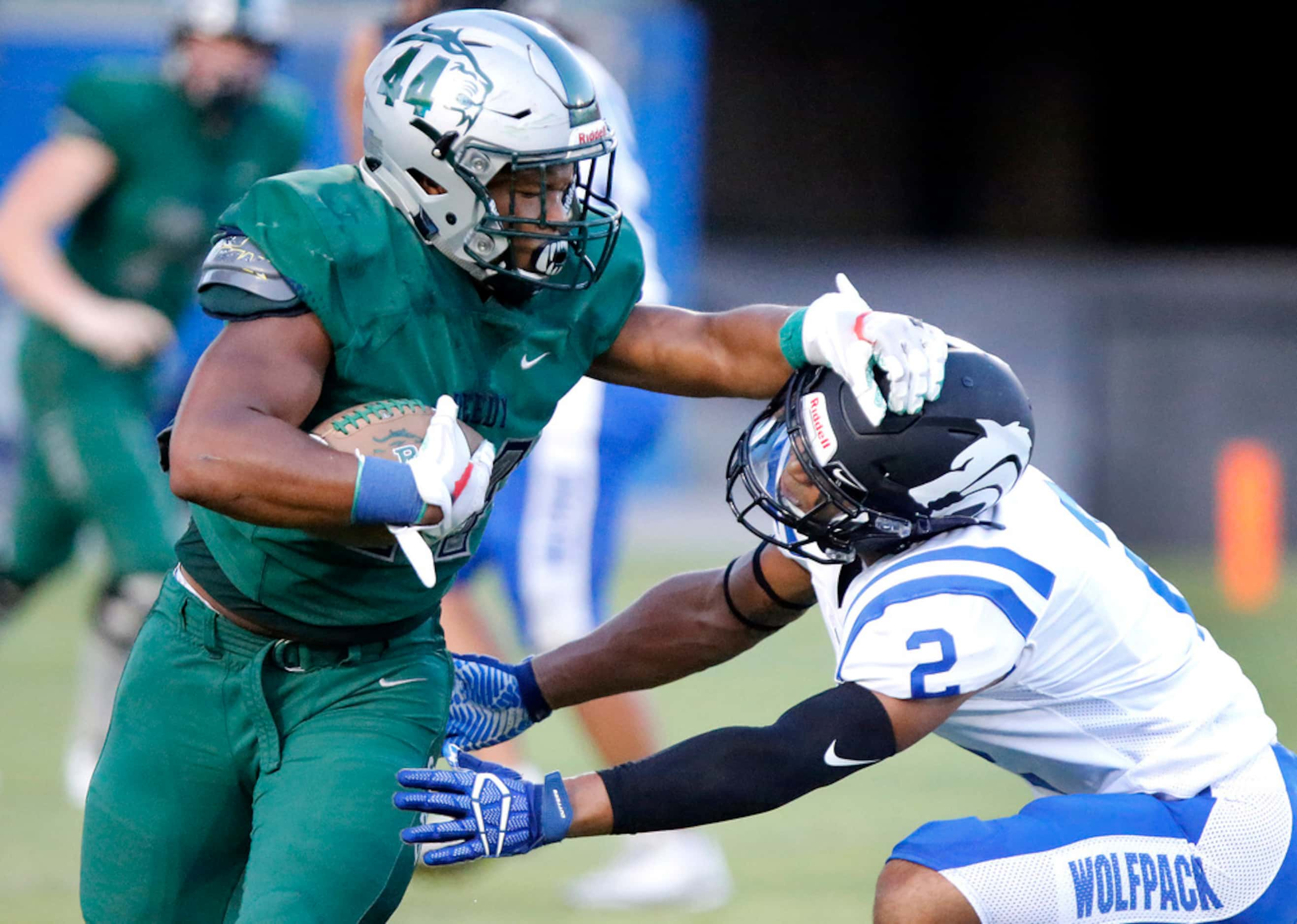 Reedy High School defensive lineman Noah Jackson (44) gives a stiff arm to Plano West High...