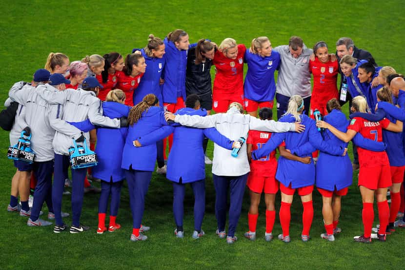 Members of the U.S. team embrace after defeating Thailand, 13-0, in their Women's World Cup...