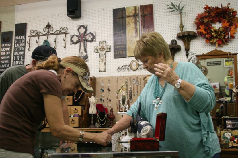 Pat Malone, owner of Ten of Arts, which she co-owns with Lynne Hosid, displays some of her...