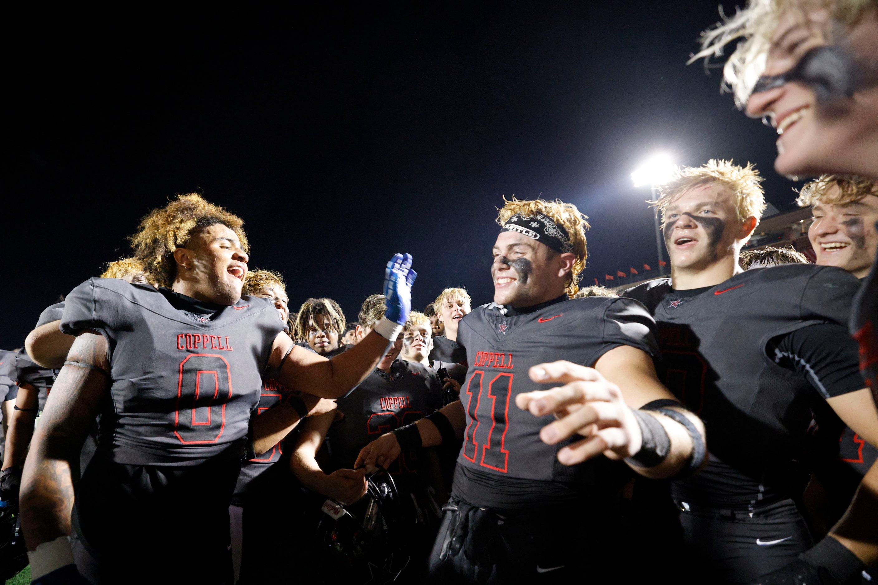 Coppell players celebrate their 35-27 victory against Prosper after a high school football...