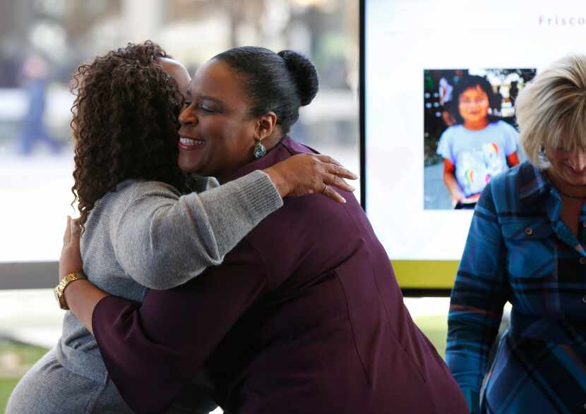 Nicole Bursey of Frisco Family Services Center hugs Leona Allen (left), board chair of The...
