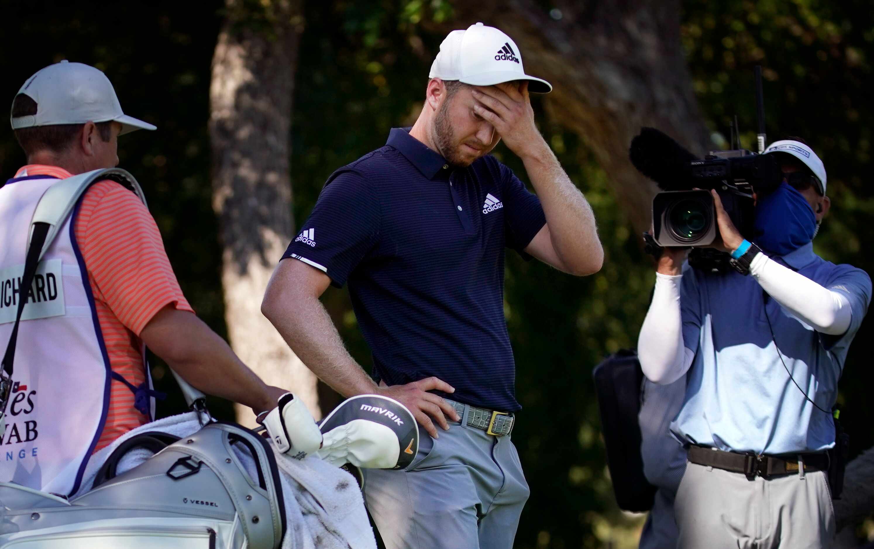 PGA Tour golfer Daniel Berger reacts after Collin Morikawa missed a putt on the first...