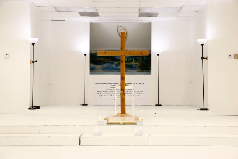 A cross sit on the stage as visitors are allowed into First Baptist Church to pay their...