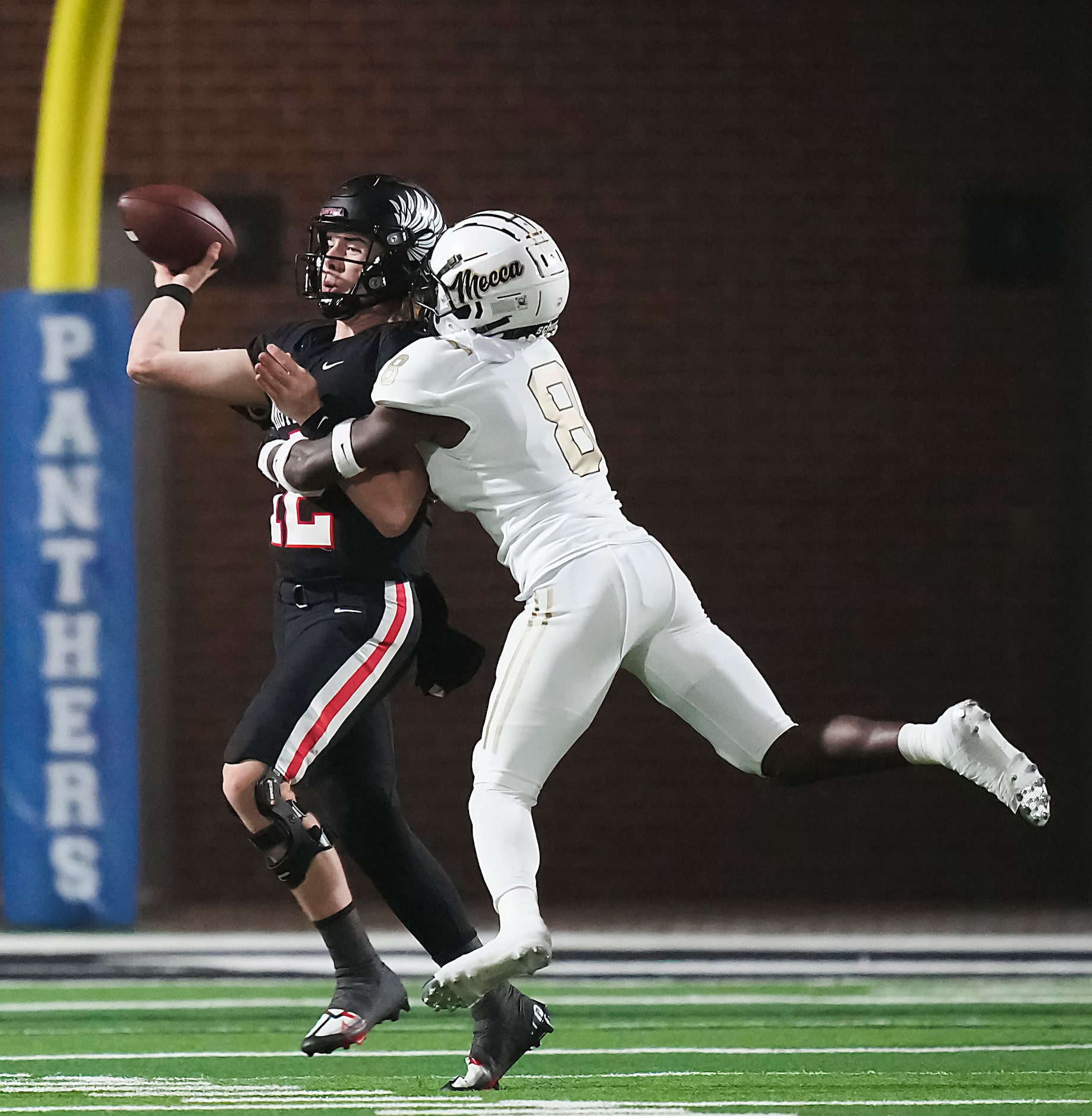 Argyle quarterback John Gailey (12) throws as he is het by South Oak Cliff linebacker ...