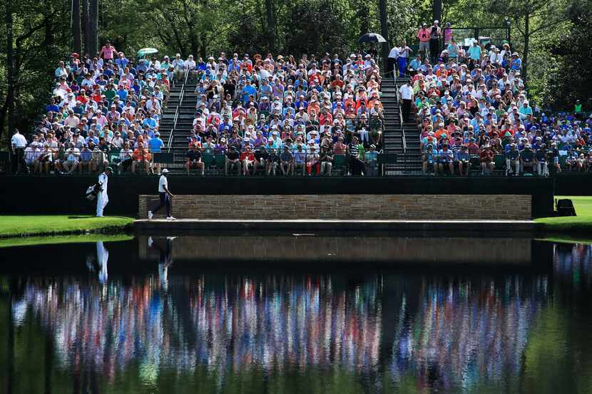 AUGUSTA, GEORGIA - APRIL 13: Tony Finau of the United States walks across the Sarazen Bridge...