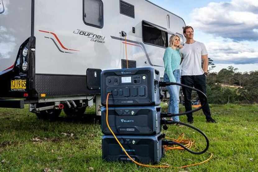 couple standing by RV