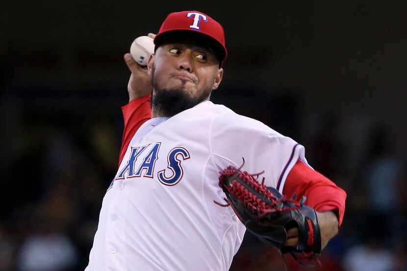 Texas Rangers starting pitcher Yovani Gallardo throws during the first inning of a baseball...
