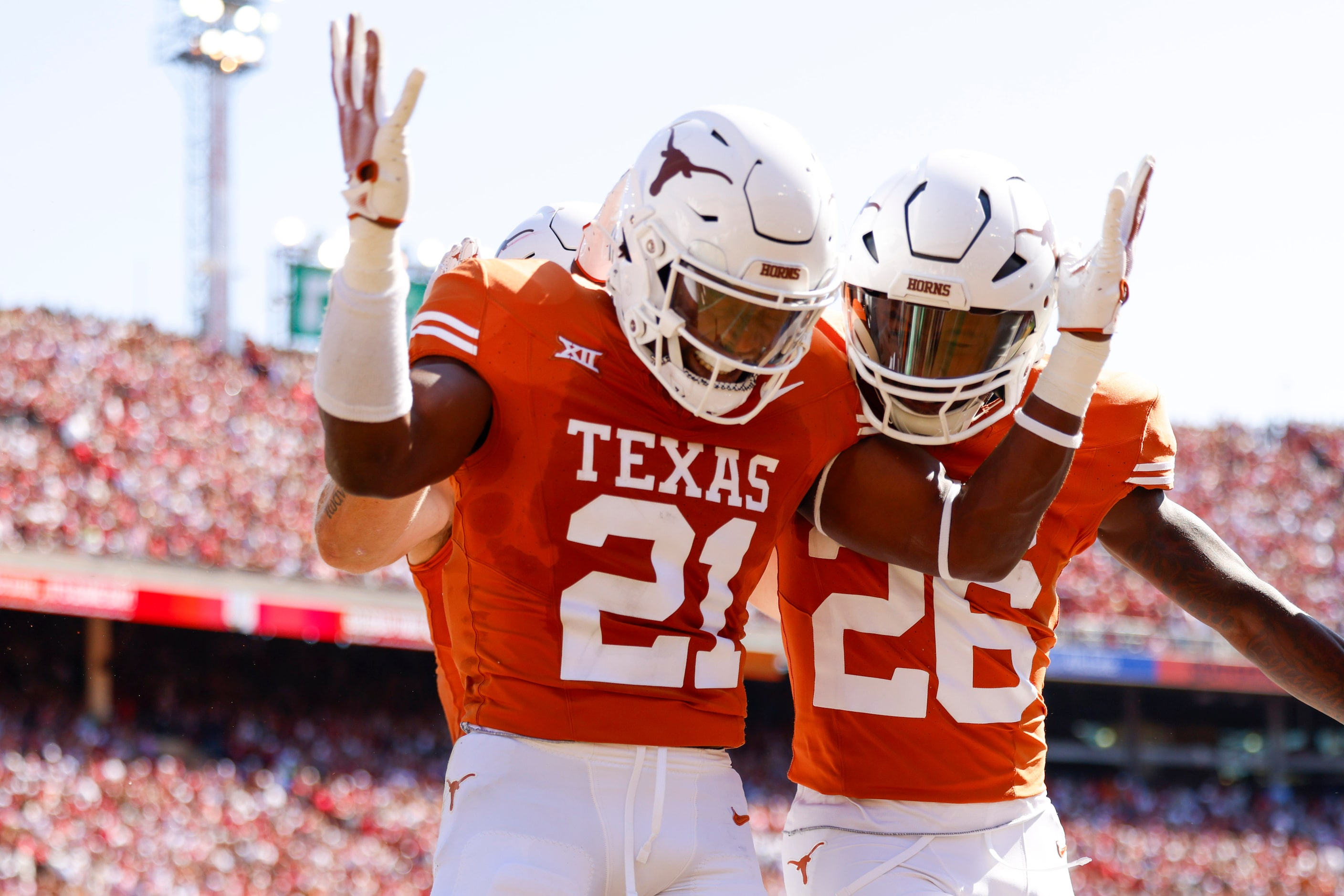 Texas defensive back Kitan Crawford (21) celebrates a touchdown alongside Texas running back...