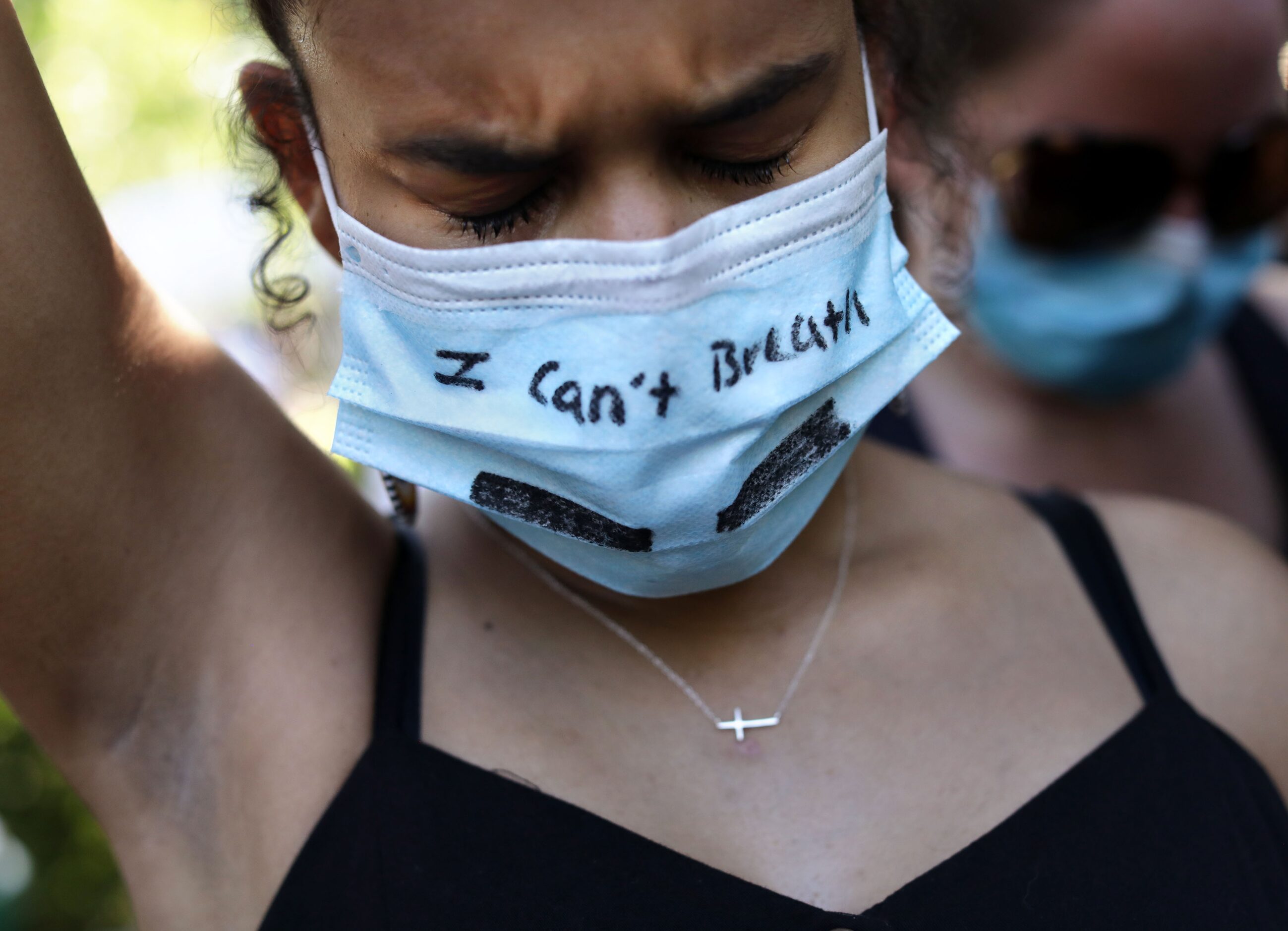 Ava McLeod takes a moment to reflect as protestors meet at the historic town square in...