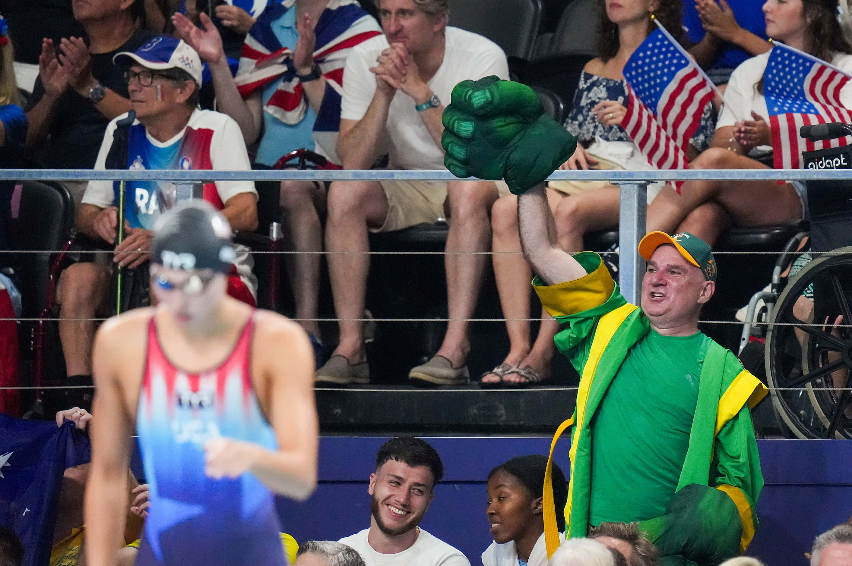 A  fan cheers for Shayna Jack of Australia as Torri Huske of the United States steps up to...