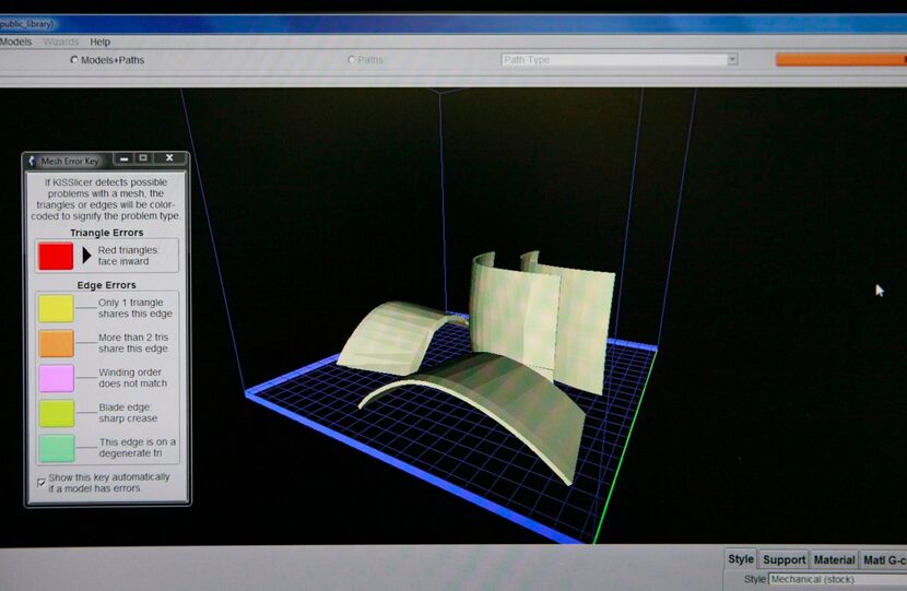 
A computer screen displays a 3-D print job being printed on the PolyPrinter 3-D printer on...