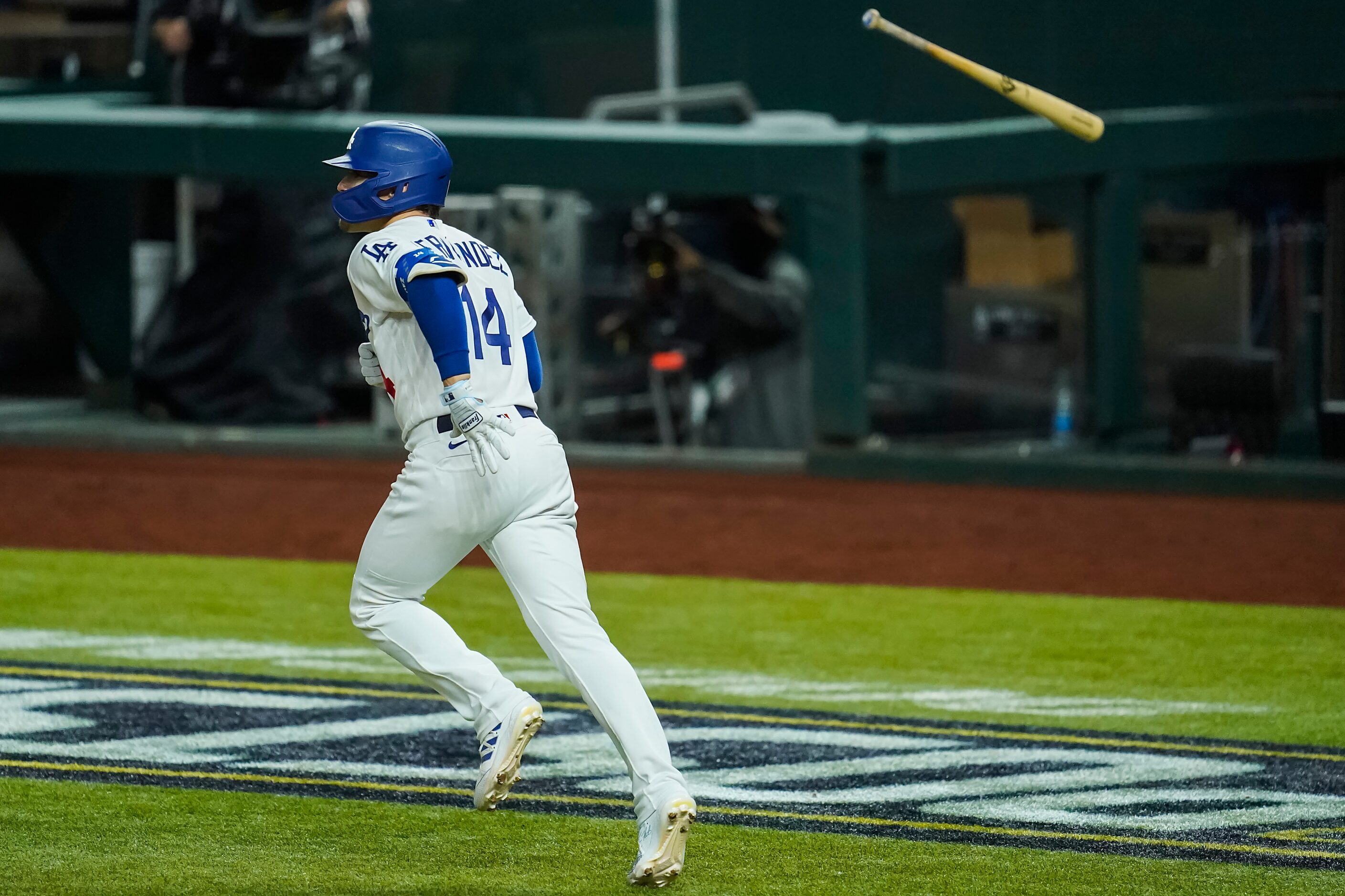 Los Angeles Dodgers pinch hitter Enrique Hernandez tosses his bat after hitting a game-tying...