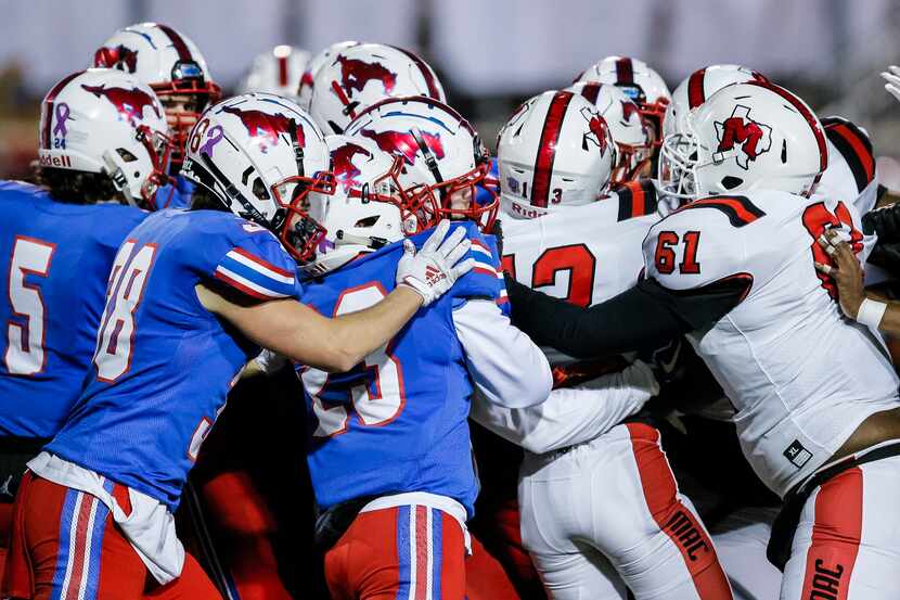 JJ Pearce defenders push back against the Irving MacArthur offense during the first half of...