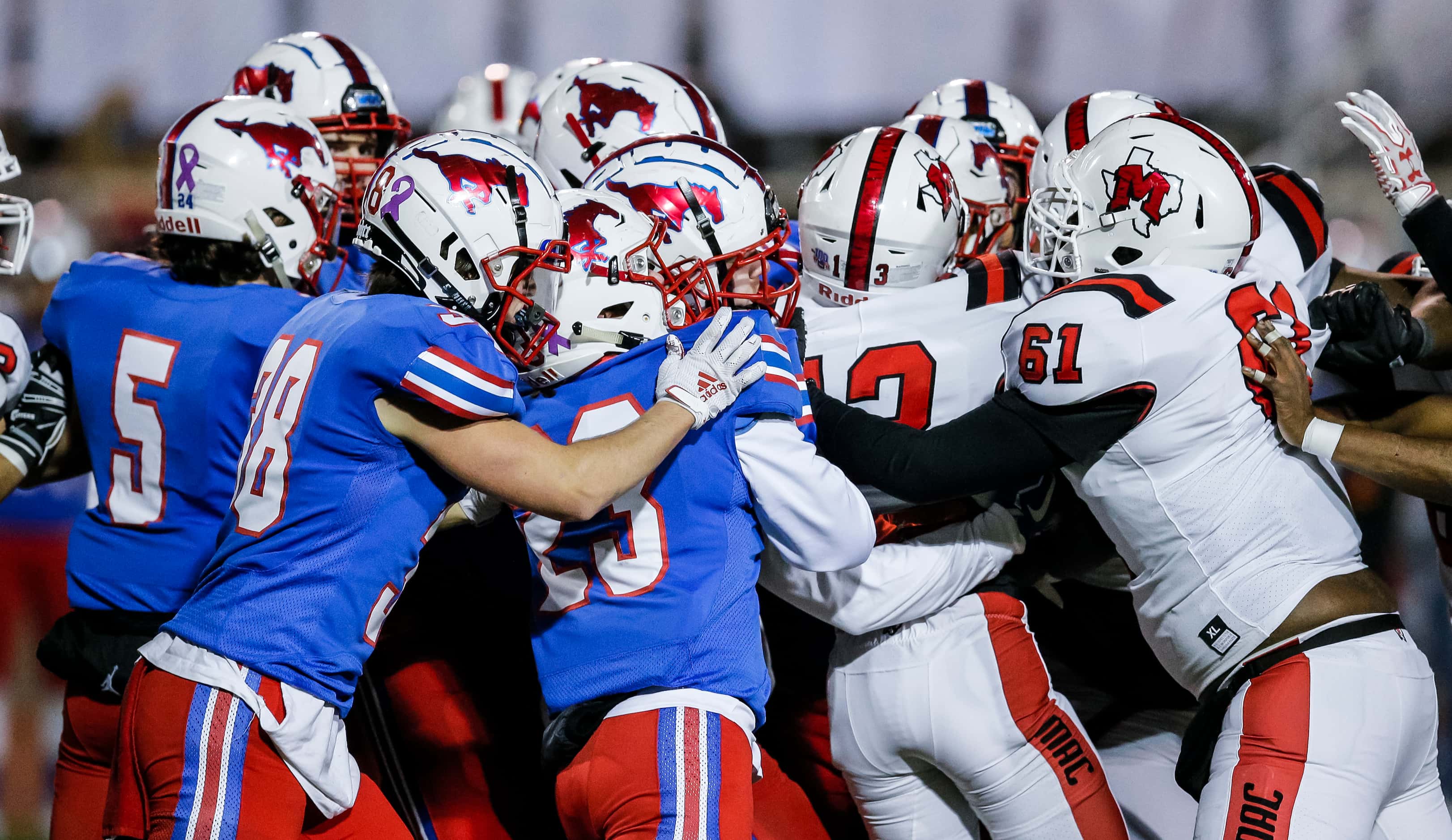 JJ Pearce defenders push back against the Irving MacArthur offense during the first half of...